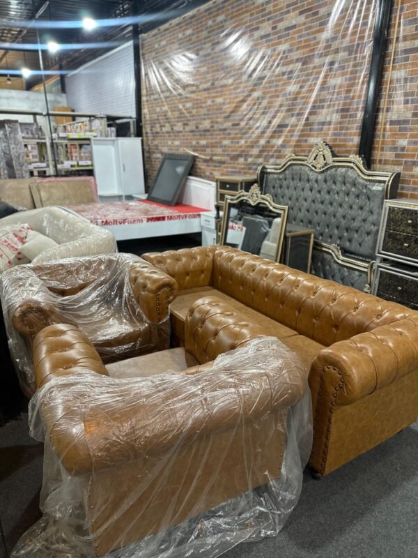 Modern brown Chesterfield sofa set with tufted design offered by Islamabad Auctioneers.