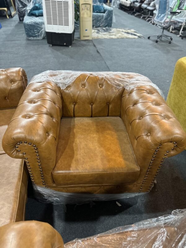 Rixin single-seater Chesterfield chair in brown with tufted design and nailhead detailing, available at Islamabad Auctioneers.